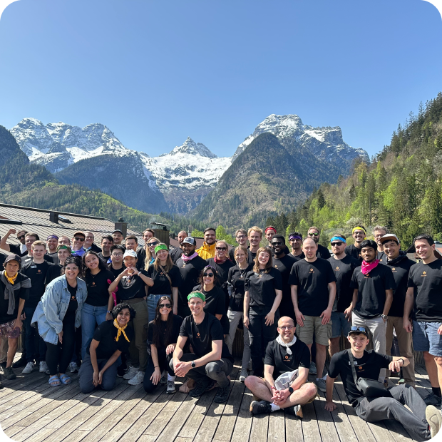 Gitpod team members sitting near the sea.