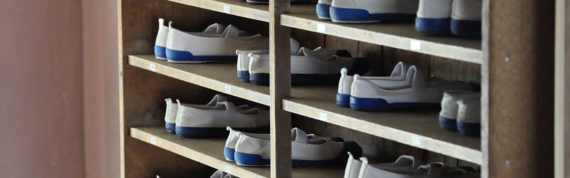 Self-service rack with available pairs of bowling shoes