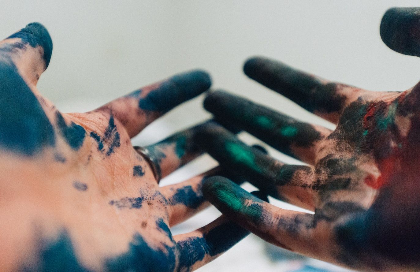Hands with paint on them.